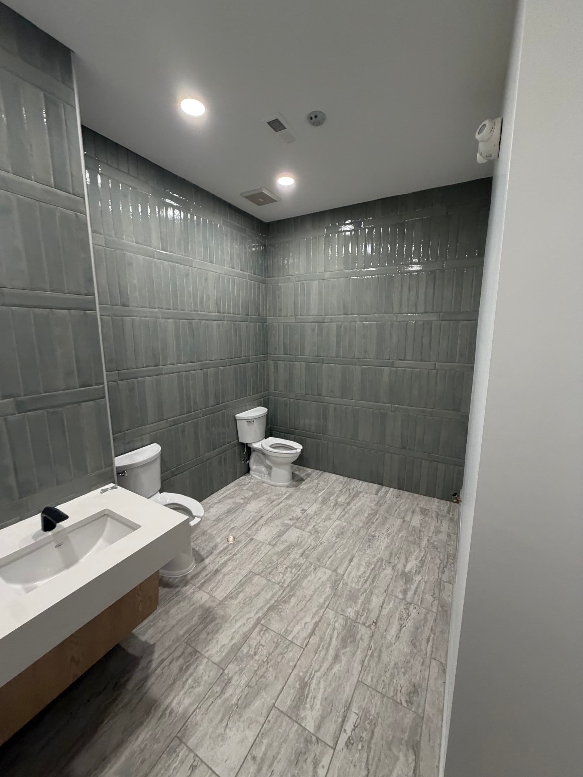 Commercial Bathroom Remodel with Black Partitions in Charlotte image